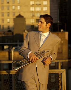 Jazz Trumpeter Dominic Farinacci poses with his trumpet against a landscape of city rooftops