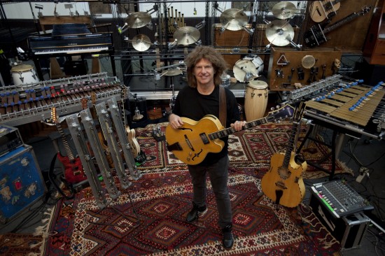 Pat Metheny surrounded by the mechanized instruments that complete his Orchestrion tour. Pat Metheny standing, surrounded by the mechanized instruments that make up his Orchestrion tour.