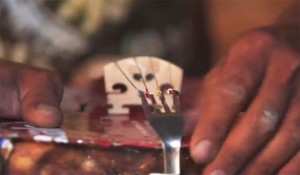 A violin made of trash, courtesy of the Recycled Orchestra. Violin made of trash, closeup on the bridge made from a fork.